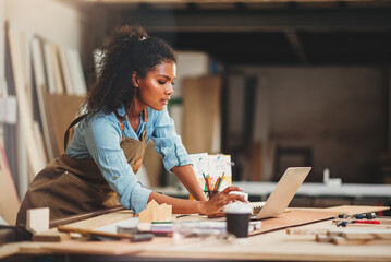African american woman craftgirl working in handmade DIY workwood workshop, Small business owner in furniture industry.