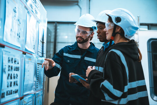 Engineer man and woman workers discussing on blueprints and working plan in factory, Professional engineer working together with teamwork.