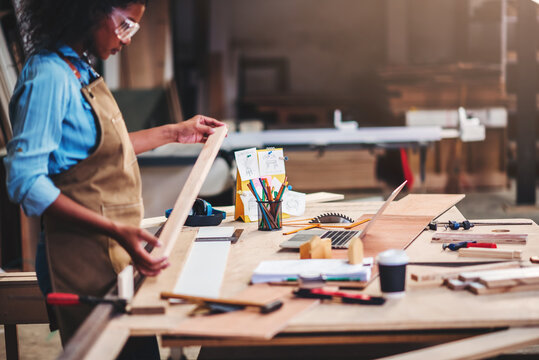 African american woman craftgirl working in handmade DIY workwood workshop, Small business owner in furniture industry.