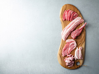 Several parts of meat on a wooden plate	