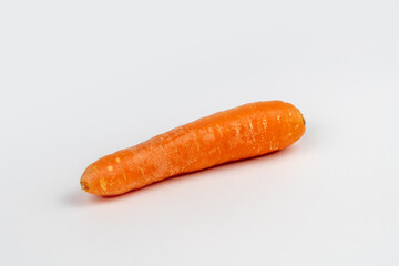 alone orange fresh carrot on gray background
