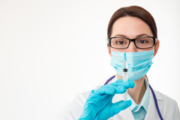 Siri Nurse holds a syringe in her hand, preparing for the introduction of a drug, vaccination concept.