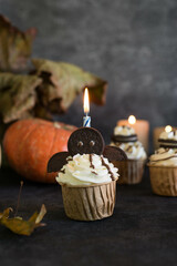 Cupcakes decorated for Halloween on a gray background.