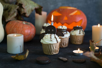 Cupcakes decorated for Halloween on a gray background.