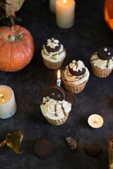 Cupcakes decorated for Halloween on a gray background.