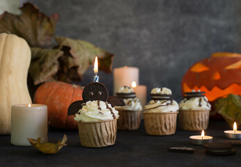 Cupcakes decorated for Halloween on a gray background.