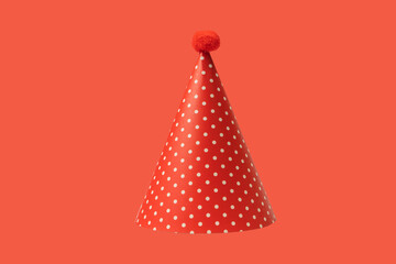 Bright and colorful birthday cap isolated on a red background.