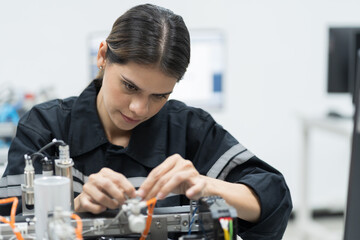 Female engineer using desktop computer for training Programmable logic controller in the...