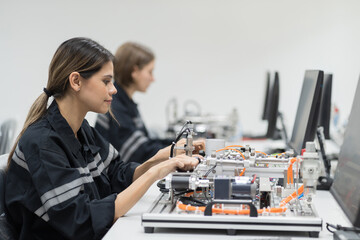 Female engineer using desktop computer for training Programmable logic controller in the...