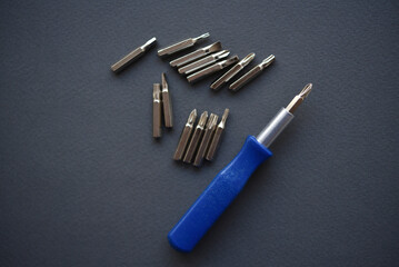 Replaceable nozzles for a screwdriver. Blue screwdriver with attachments.