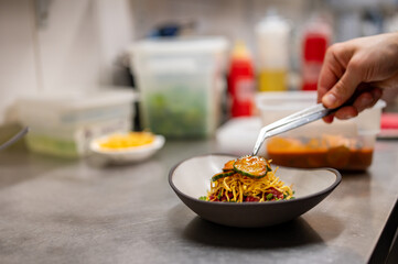 professional chef's hands cooking Raw beef meat tartar in restaurant kitchen