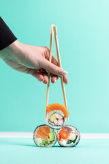 Savoring Delicious Sushi Between Chopsticks