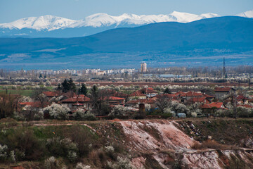 Obraz premium View made over the lake in the former Kremikovtsi mine and views of Sofia and Vitosha Mountain.