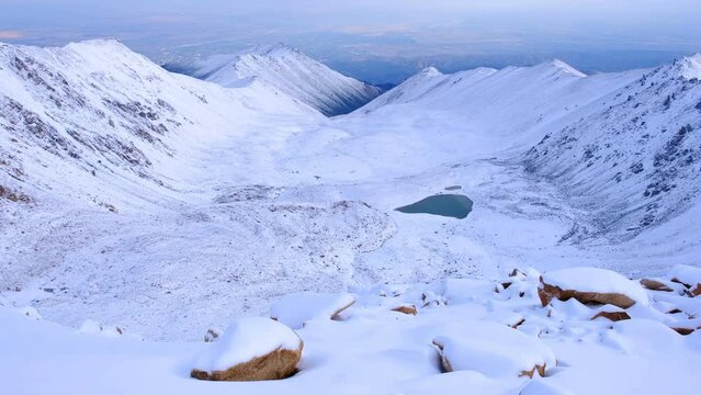 Delightful panorama of the snow-covered highlands with moraine lakes in winter season