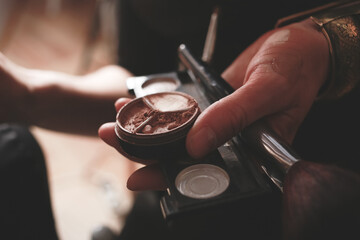 Woman holding a make up tools and powder cream close up