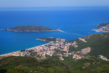 Fototapeta na wymiar View of the city from the top of the mountain road. View of the coast and the city of Budva Riviera. Montenegro, Balkans, Adriatic Sea, Europe.