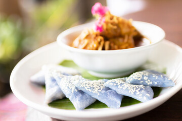 'Hung Lay' curry with pork served with steamed glutinous rice. This curry from northern Thailand is like no other. Slow-simmered, slightly sweet and tangy, and full of rich, complex flavors.