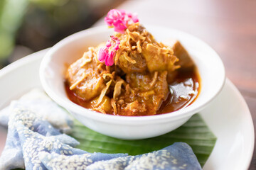 'Hung Lay' curry with pork served with steamed glutinous rice. This curry from northern Thailand is like no other. Slow-simmered, slightly sweet and tangy, and full of rich, complex flavors.