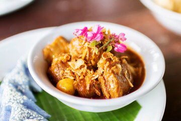 'Hung Lay' curry with pork served with steamed glutinous rice. This curry from northern Thailand is like no other. Slow-simmered, slightly sweet and tangy, and full of rich, complex flavors.