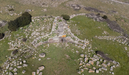 Archeological ruins of Nuragic necropolis Giants Tomb of S’omu de S’orcu - Tomba di Giganti Omu de Orcu - with front grave stones of Neolithic cemetery
