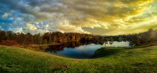 Stunning landscape image of Tarn Hows in Lake District during beautiful Autumn Fall.