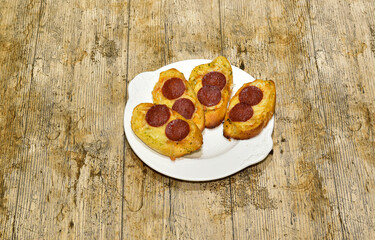 Pizza Garlic bread with pepperoni on a white plate