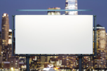 Fototapeta premium Blank white horizontal billboard on skyline background at evening, front view. Mock up, advertising concept
