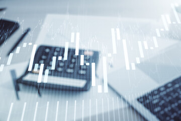 Multi exposure of virtual abstract financial graph interface on blurry calculator and computer background, financial and trading concept