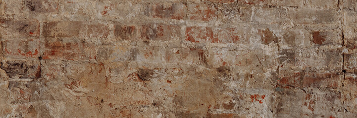 Background or background of an old vintage dirty brick wall with peeling plaster. Texture of cracked red bricks. Banner for website header design with copy space.