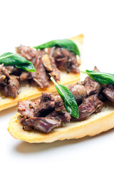 roasted livers on toasted baguette with sage leaves