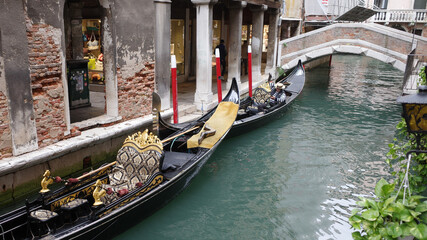 Venice, Italy - Nov 14, 2022: Traditional Gondolas navigate the narrow canals of Venice