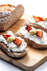 garlic spread on slice of bread served with bacon, grated cheese and mustard