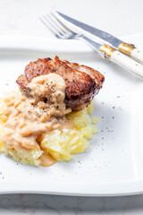 grilled meat with mashed potatoes with onion sauce