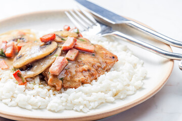 pork fillet with mushroom sauce and ham served with white rice