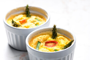 baked eggs with green asparagus, tomato and spring onion