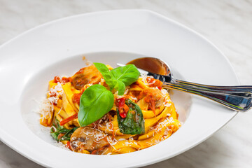 pasta tagliatelle with tomato sauce,champignon and basil leaves