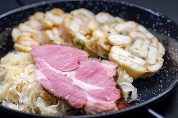 smoked meat served with sauerkraut and dumplings
