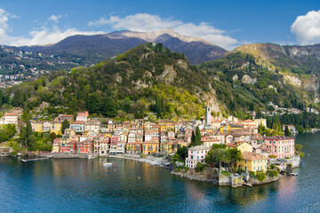 Naklejka na ściany i meble Beautiful aerial waterfront cityscape of Varenna, one of the most picturesque towns on the shore of Lake Como. Charming location with typical Italian atmosphere. Varenna, Italy.