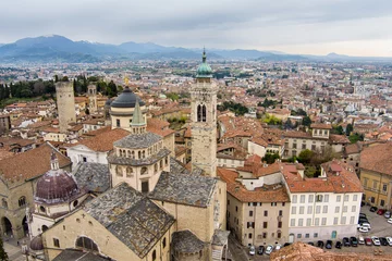Deurstickers Scenic aerial view of Bergamo city. Flying over Citta Alta, town's upper district, known by cobblestone streets and encircled by Venetian walls. Bergamo, Lombardy, Italy. © MNStudio