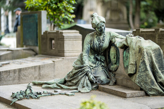 Impressive sculptures on the tombs and monuments of Cimitero Monumentale di Milano or Monumental Cemetery of Milan. Milan, Italy.