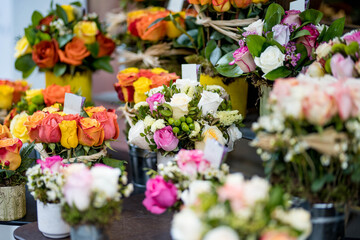 Beautiful rose bouquets sold on outdoor flower shop in Milan, Italy