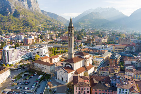 Sunny aerial cityscape of Lecco town on spring morning. Picturesque waterfront of Lecco town located between famous Lake Como and scenic Bergamo Alps mountains.