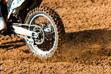 A young man, a man, an athlete, driving a motocross motorcycle on a dirt track. Movement, slow...