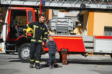 Firefighter holding child boy to save him in fire and smoke,Firemen rescue the boys from fire