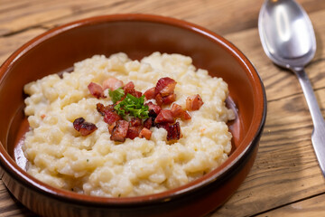 Slovakian halusky served with sheep cheese and roasted bacon