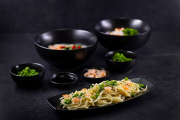 Various dishes of Asian cuisine with different types noodles and rice with shrimp, duck, vegetables and black sesame
