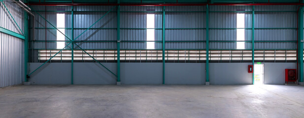 Interior of empty warehouse. Clean and empty industrial hall in detail for supporting poles....