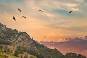 paragliding with eagles over the mountain at sunset. Paragliding in the Caucasus Mountains