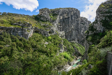Fototapeta na wymiar Big mountains of large Verdon canyon and small mountain river in the bank of valley