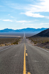 Looking along a long straight road on the way to Death Valley